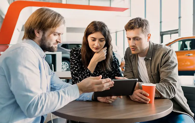 Family at dealer | CarMoney.co.uk