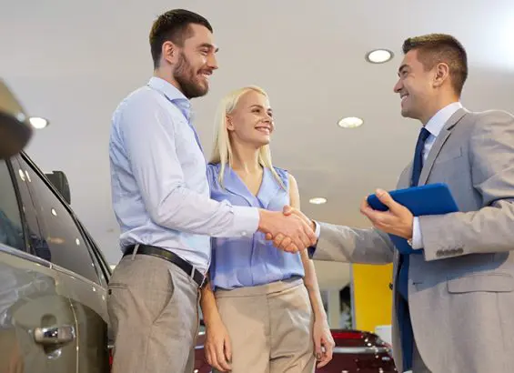 Couple buying car at dealer | CarMoney.co.uk