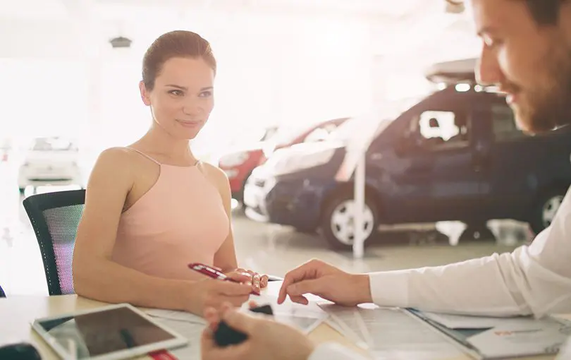 Woman at dealer | CarMoney.co.uk