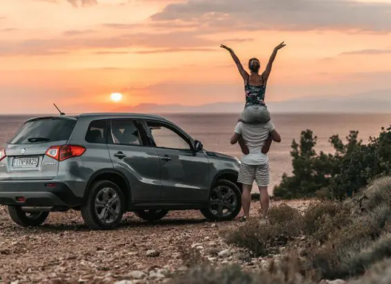 Suzuki on beach at sunset | CarMoney.co.uk