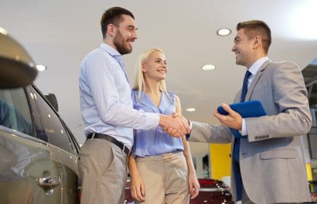 Couple buying car at dealer | CarMoney.co.uk